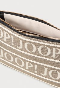 Béžová tkaninová taštička s bílým textovým vzorem "JOOP!". Zapínání na zip s hardwarem ve zlatém tónu, vnitřní podšívka je hladká.