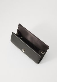 Black leather wallet with a smooth texture and a snap closure. Interior features multiple card slots and a spacious compartment.