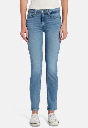 Jean skinny bleu clair en denim, avec taille mi-haute, cinq poches, un léger effet délavé et une fermeture éclair avec un bouton en métal.