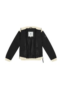 Veste noire avec col et poignets côtelés beiges, ouverte pour montrer la doublure intérieure noire lisse et la boucle de suspension au niveau du cou.