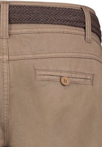 Beige pants featuring a woven brown waistband, a rear pocket with a button closure, and smooth, lightweight fabric.