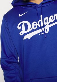 Sweat à capuche bleu en tissu lisse, avec le texte blanc "Dodgers" et un petit logo Nike sur la poitrine. Comprend une capuche avec cordon de serrage.