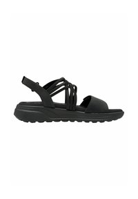 Black sandal with a flat sole, featuring a wide front strap and multiple crossover straps. Soft material with textured accents.