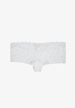 Culotte en dentelle blanche avec un motif floral, des bords festonnés et un tissu doux. Comprend une partie centrale pour le confort et l'ajustement.