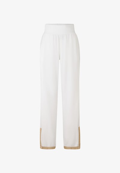 Witte sweatpants met een brede tailleband, voorzien van een gestructureerde zoom en beige accenten aan de onderkant. Gemaakt van zachte, lichte stof.