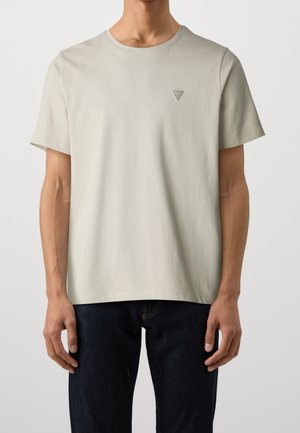 Light gray cotton T-shirt with short sleeves, crew neck, and a small logo on the left chest. Simple, minimalist design.