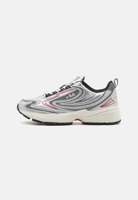 Silver athletic sneaker with mesh upper, red accents, and black sole. Features curved design lines and a lace-up closure.