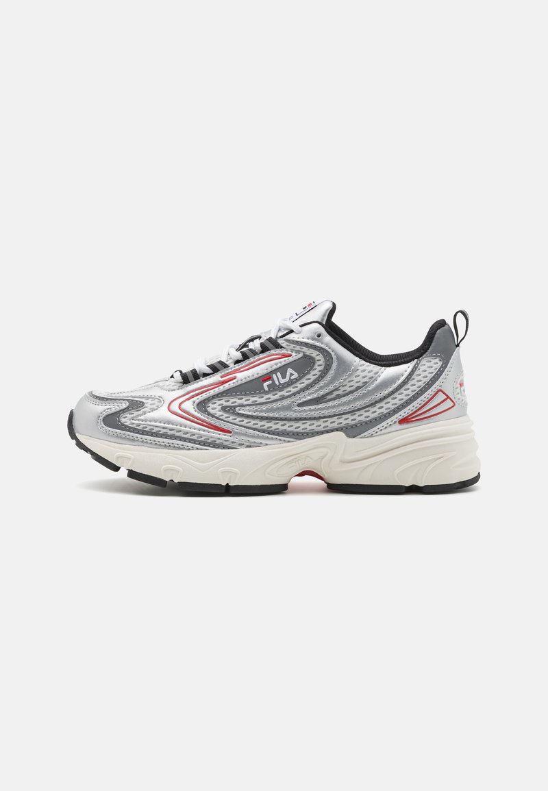 Silver athletic sneaker with mesh upper, red accents, and black sole. Features curved design lines and a lace-up closure.