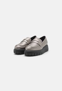 Metallic silver loafers with textured surface, a broad black platform sole, and a simplistic design featuring a classic stitched pattern.