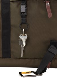 Brown and black fabric bag features a snap buckle, a key ring with keys, and a silver metal carabiner with a yellow accent.