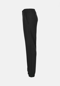 Pantalons de survêtement noirs en tissu doux, dotés d'une taille élastique, de poches latérales et de poignets ajustés. Design simple avec un minimalisme dans les détails.