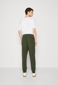 BOSS HADIKO - Treniņtērpa apakšdaļas - open green