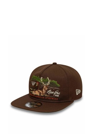 Brown snapback cap featuring embroidered deer, green trees, "New Era 1920," and "Heritage American Sportwear" text on the front panel.