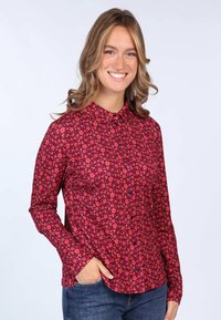 Long-sleeve shirt in red with a floral pattern, featuring a collar, button front, and a slightly fitted design. Soft, lightweight fabric.