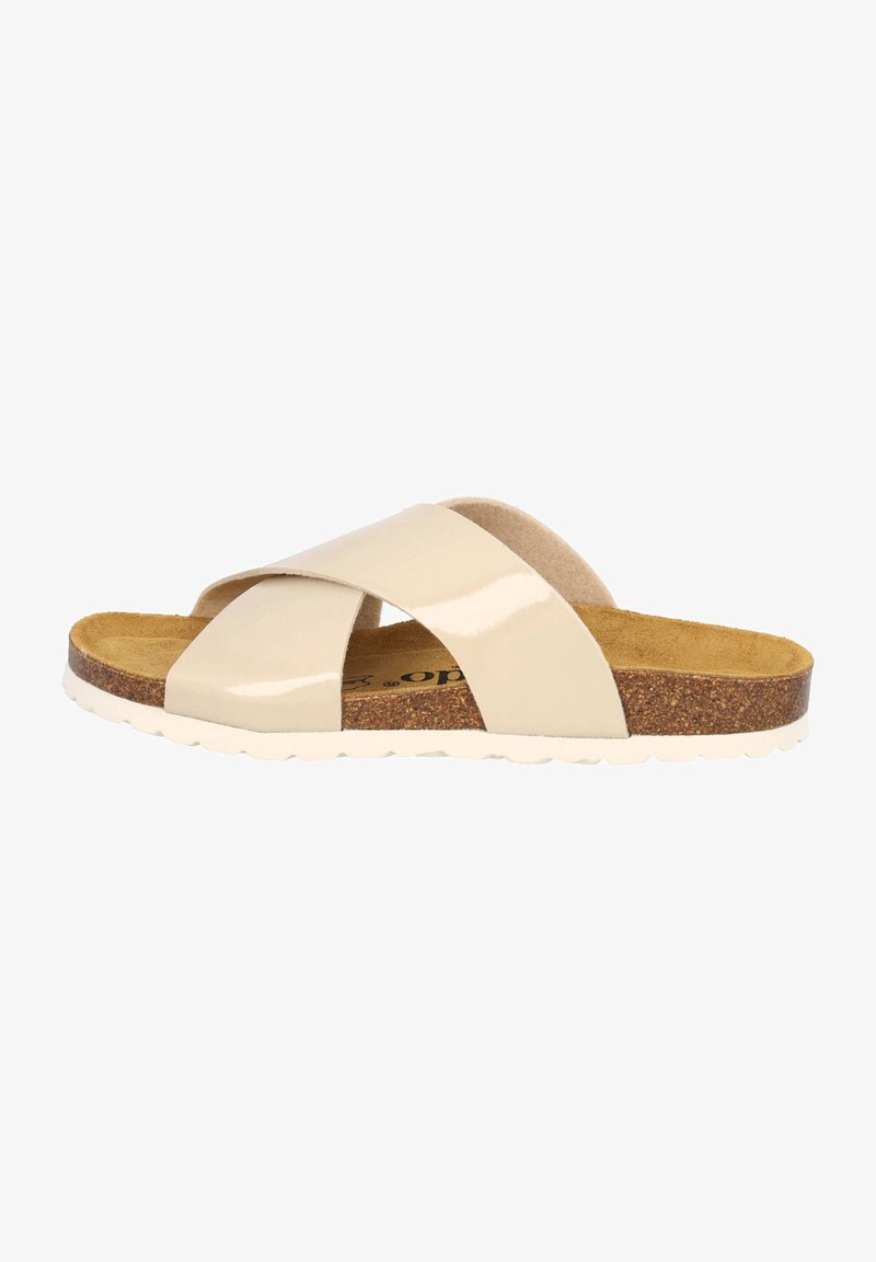 Beige Lack-Sandale mit Korkfußbett, Kreuzbanddesign und rutschfester weißer Sohle für zusätzlichen Halt.