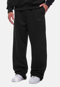 Dropsize - OPEN LEG - Tracksuit bottoms - black Thumbnail Image 1