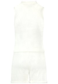 White sleeveless top and matching shorts set with a subtle woven pattern, featuring a high collar and rolled cuffs at bottom hem.