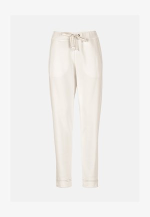 Priložna kremasto obarvana hlače z vrvico v pasu in stranskimi žepi, z ozkimi hlačnicami in zložene hlačne robove.