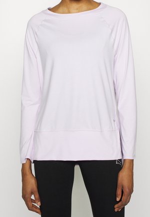 Light lavender long-sleeve top with a rounded neckline, raglan sleeves, and side slits at the hem; fabric appears soft and stretchy.