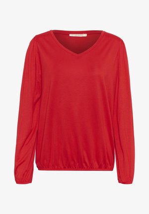 Haut rouge à manches longues en V avec des manches froncées, un ourlet élastique et une texture lisse. Il présente un design simple et classique.