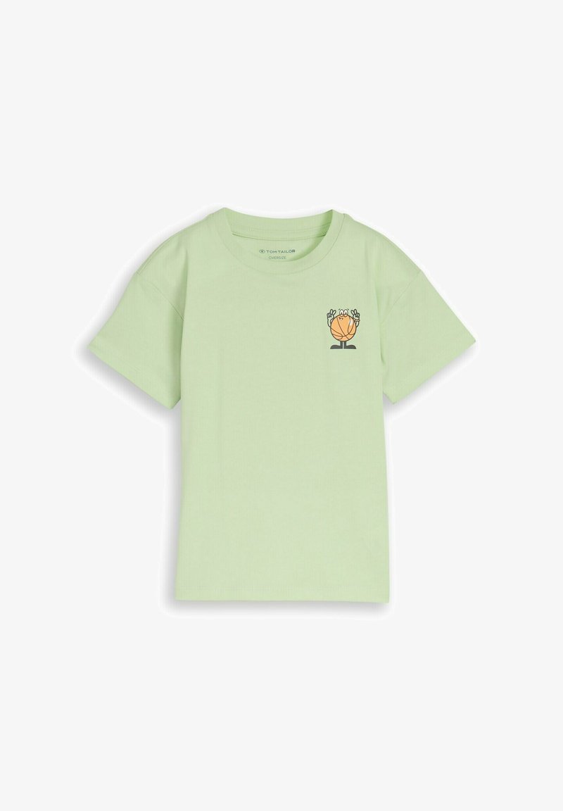 T-shirt vert clair à manches courtes avec un petit personnage de basket-ball en dessin animé montrant des signes de paix sur le côté gauche de la poitrine.