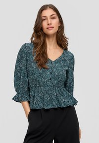 Türkisfarbene Blumen-Peplum-Bluse mit V-Ausschnitt, gerafften Ärmeln und Knopfdetails. Hergestellt aus leichtem Stoff mit einem strukturierten Muster.