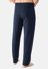 Mörkblå bomullspyjamasbyxor med elastisk midja, rak passform och en bakficka. Mjuk och lätt tyg.