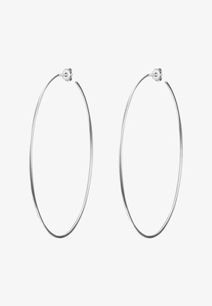 Boucles d'oreilles créoles en argent avec une finition lisse et polie. Elles sont grandes, de forme circulaire, et dotées d'une fermeture à poussette.
