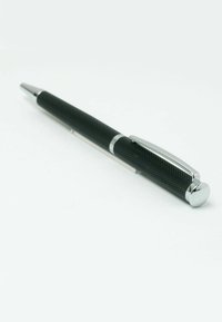 Black metal pen with a knurled texture, chrome accents, and a rounded cap. The design is sleek with a smooth barrel and traditional clip.