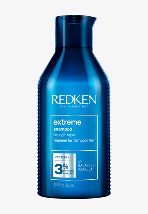 Bottiglia blu di shampoo Redken Extreme per riparazione e rinforzo, 300 ml, con complesso di proteine al 3% e formula a pH bilanciato per capelli danneggiati.