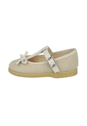 Zapato Mary Jane de lona beige con punta redonda, detalle de lazo en la parte delantera y correa ajustable con hebilla de plata. Suela de goma.