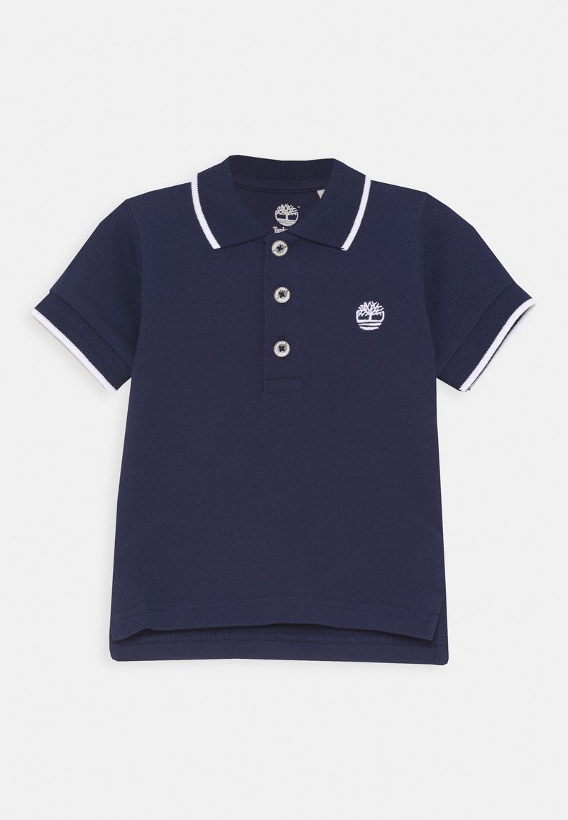 Polo bleu marine à manches courtes avec bordure blanche au col et aux manches, trois boutons, et un logo arbre blanc sur la poitrine.