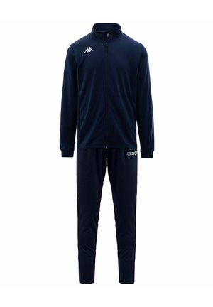 Tuta blu navy con giacca con zip, colletto alto e polsini elasticizzati, abbinata a pantaloni affusolati coordinati. Logo Kappa su giacca e pantaloni.
