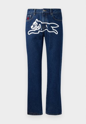 Blue denim jeans with straight legs, featuring a large white graphic of a leaping creature on the back pocket. Standard five-pocket design.