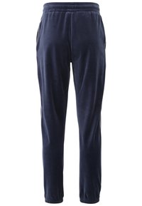 Navyblåa velour-joggingbyxor med elastisk midja, sidofickor och tapered design. Slät textur, subtil lyster.