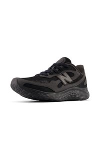 Black athletic shoe with mesh upper, padded collar, and textured sole. Features a signature logo and ribbon laces. Lightweight design.