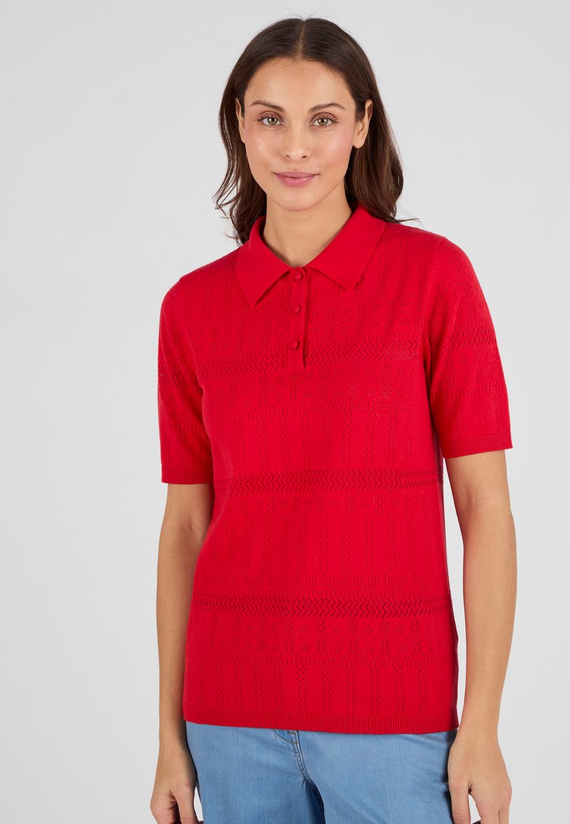 Rode polo shirt met korte mouwen, voorzien van knoopsluiting en gestructureerde breipatronen. Beschikbaar in een relaxte pasvorm met een kraag.