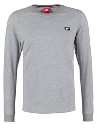 Grauer Langarm-Sweatshirt aus Baumwollmischung, mit rundem Halsausschnitt, gerippten Bündchen und einem kleinen schwarzen Nike-Logo auf der linken Brust.