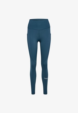 Teal hochtaillierte Leggings aus dehnbarem, glattem Material. Verfügt über Seitentaschen und ein Logo nahe dem Knöchel. Figurbetontes Design.
