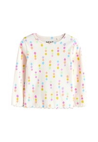 Hvid top med lange ærmer, der har en ribbet tekstur prydet med flerfarvede prikmønstre i pink, blå, gul og grøn. Kant med bølget detalje.