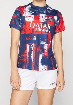 Person wearing a blue, red, and white Paris Saint-Germain soccer jersey with Qatar Airways logo and white Nike shorts.
