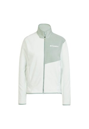 Chaqueta de polar de color claro con diseño de media cremallera, detalles en verde, dos bolsillos laterales y un logo en el pecho. Textura suave.