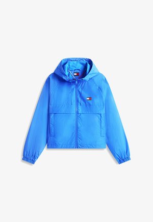 Felblauwe gewatteerde jas met capuchon, ritssluiting aan de voorkant, elastische manchetten, twee zakken aan de voorkant en een klein rechthoekig logo op de borst.