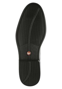 Schwarze Schuhsohle mit einem strukturierten Muster, die eine zentrale Linie und ein kreisförmiges Logo in Orange aufweist, entworfen für Griffigkeit und Langlebigkeit.