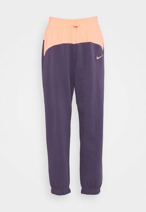 Athletic pants with elastic peach waistband and cuffs, dark purple lower section, and small peach Nike swoosh on thigh.