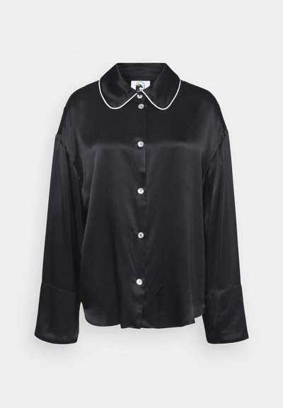 Black satin blouse featuring a classic collar, long sleeves, and white trim. It has a button-down front with shiny decorative buttons.