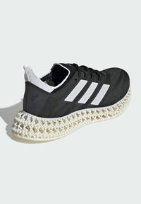 Black athletic shoe with a textured upper, white accents, and a uniquely shaped, lattice-style midsole. Rubber outsole for grip.