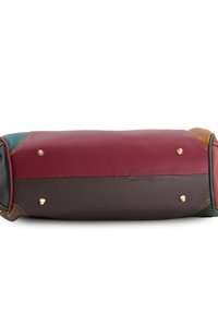 Leather bag featuring a burgundy top section, dark brown base, and green accents. Gold hardware and stitching visible. Textured surface.