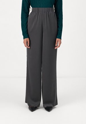 Charcoal gray wide-leg pants made from smooth fabric with an elastic waistband, paired with a teal textured long-sleeve top.