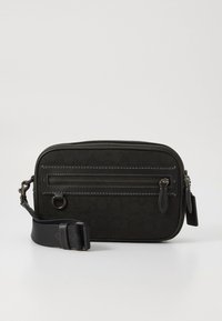 Black crossbody bag with textured fabric, zippered front pocket, adjustable strap, and metal hardware accents. Rectangular shape.